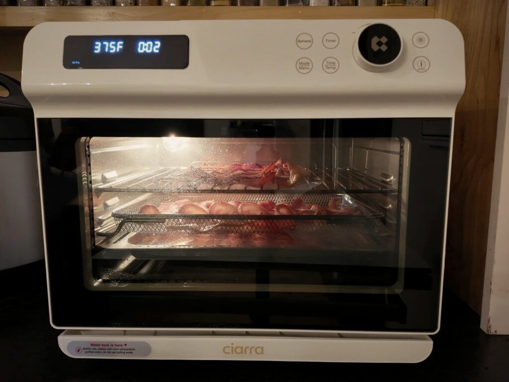 Ciarra countertop oven air frying bacon at 375°F, with an Instant Pot beside it.