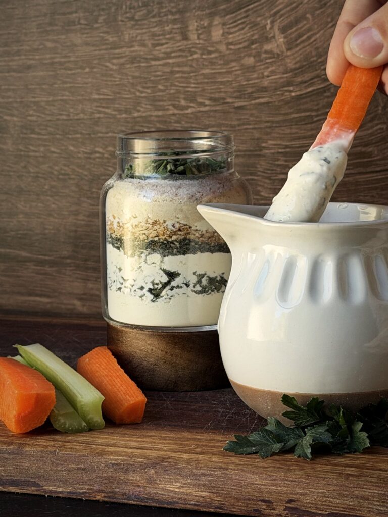 Carrot stick coated in homemade ranch dip made with homemade ranch seasoning mix